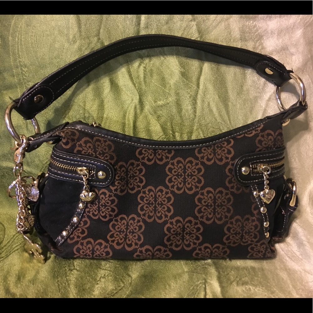 Kathy Van Zeeland handbag with charms.  Like new!